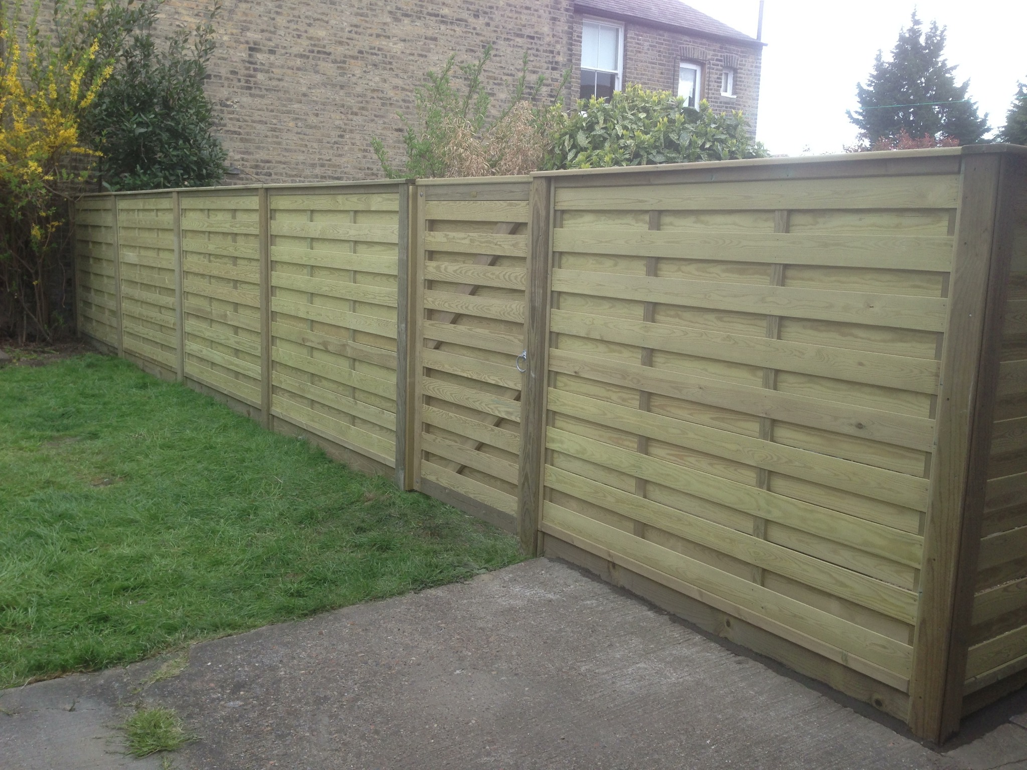 Horizontal timber panels with a matching garden gate.
