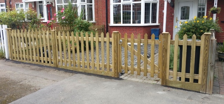 Timber picket fencing with matching gates along a front garden.